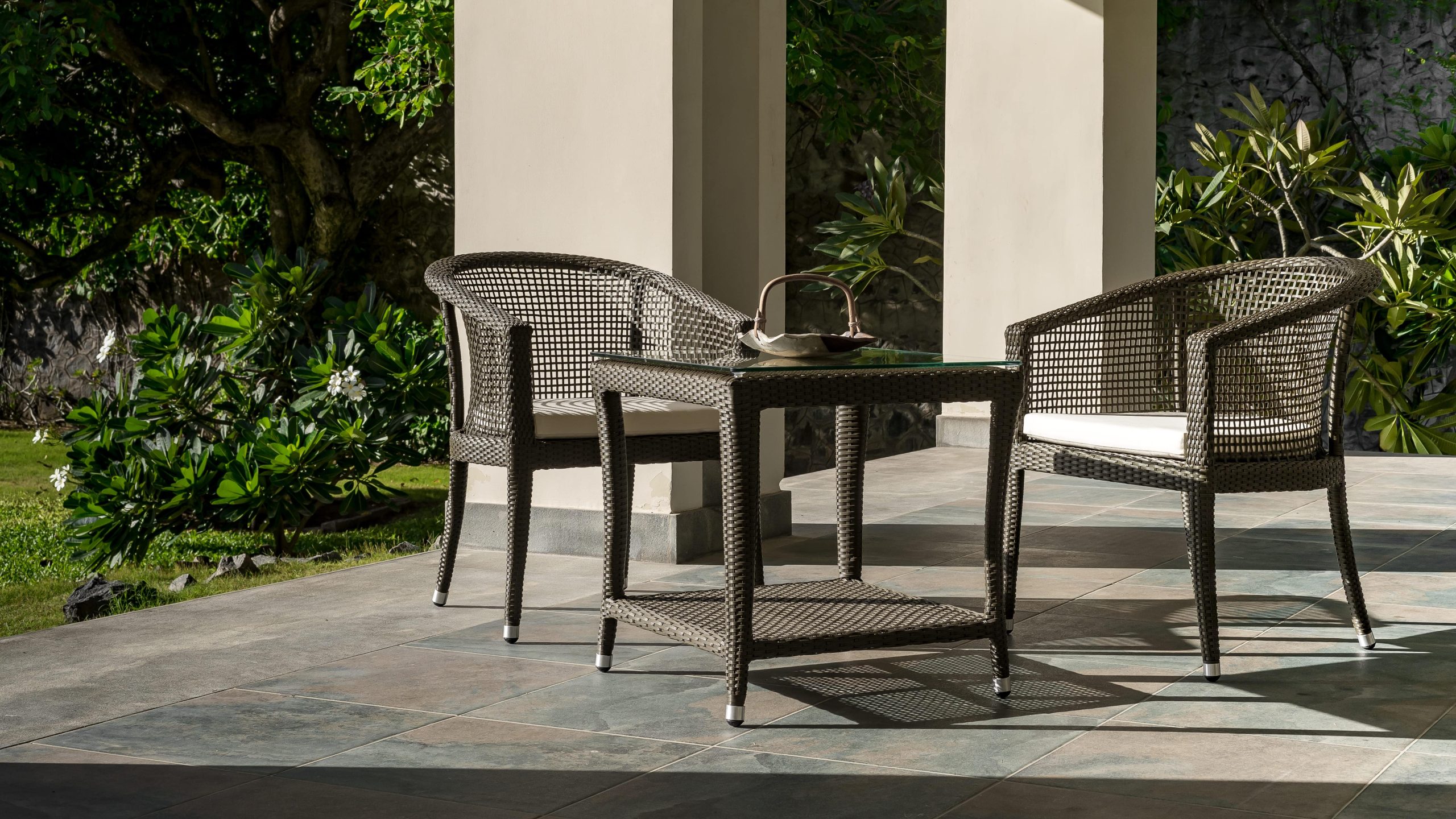 Balcony Outdoor Furniture set with two woven chairs and a glass-top table for stylish patio seating.