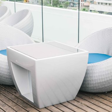Modern white wicker outdoor furniture with round chairs and a square table on a wooden deck in Chennai.