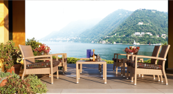 Floyd Modern Outdoor Furniture Set with Cushioned Chairs and Glass-Top Table Overlooking Lake and Mountains